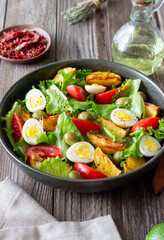 Salad with potatoes, tomatoes, olives and eggs. Healthy food. Vegetarian food.