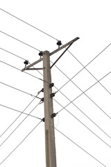 concrete electric pole with four wires running across, isolated against a bright blue clear sky,...