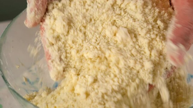 Woman grinds into crumb butter with flour in bowl cooking shortbread dough. Recipe cuisine culinary ingredient. Baking, preparing dessert, homemade fresh meal on kitchen. Make cook fresh meal, pastry.