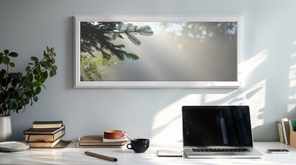 A white rectangular frame hanging in a cozy home office above a desk with a cup of coffee, a laptop, and some books. HD 8K mockup wallpaper Photographic Image