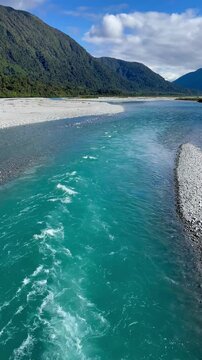 view from the Stanley Gooseman bridge on stunning turquoise flowing Taramakau river near Arthur's Pass village in southern alps, canterbury, new zealand south island; ra
