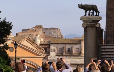 View of the Roman Forum from via San Pietro in Carcere, adjacent to Piazza del Campidoglio. People from behind take a picture of Rome.