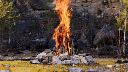 Beautiful Crackling Campfire in a Rocky Landscape , Sunrise , Authentic Place