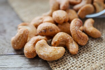 Close up of Salted cashew nuts on wooden background