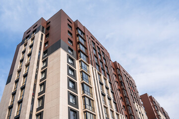 The facade of a new apartment building against the sky .