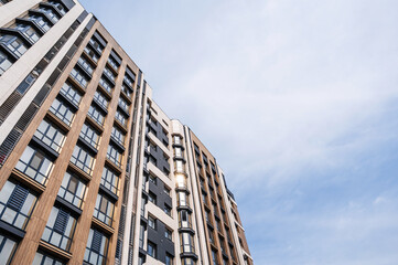 The facade of a new apartment building against the sky .