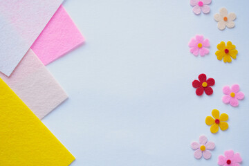 Handmade felt flowers on pastel background, DIY craft materials, creative sewing, colorful fabric...