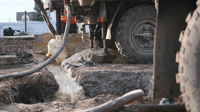 Rotary drill rig drilling water well borehole closeup shot