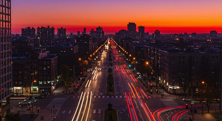 Fototapeta premium Cityscape at dusk with long exposure car light trails