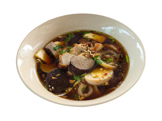 Traditional Thai-style Chinese roll noodle soup with blood pudding, egg, herbs, and garlic in a rich dark broth served in a ceramic bowl