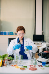 Fototapeta premium Scientist analyzing food samples in modern lab with advanced equipment for safety, nutrition, and biotechnology research.