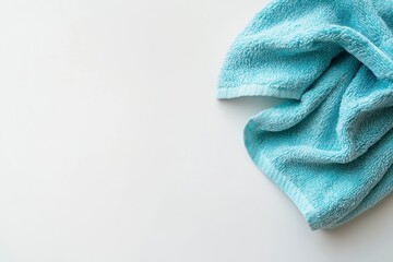 Light Blue Towel Lying Flat on White Surface for Bathroom or Spa