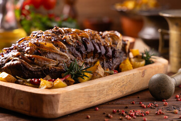 Roasted whole pork neck. Stuffed with onion slices. Served with baked potatoes.