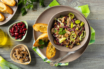 Spring salad with red beans and mushrooms. Served with croutons and garlic butter.