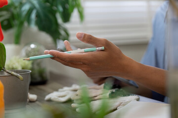 Gardening and Sustainability. A person engages in eco-friendly gardening practices while preparing...