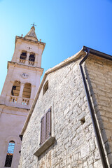 Fototapeta premium Fortified Church of St. Mary in Jelsa old town on the Adriatic island of Hvar in the county of Split-Dalmatia in Croatia