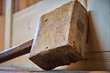Wooden mallet. A hammer used by a carpenter in a workshop. Selective focus