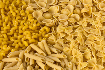 Pasta. Various kinds of uncooked pasta , top view . Pasta background .