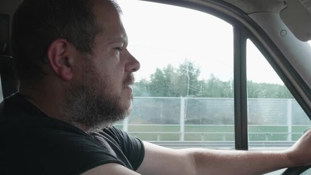 A truck driver struggles to keep his eyes open before momentarily dozing off at the wheel, creating a highly dangerous situation.