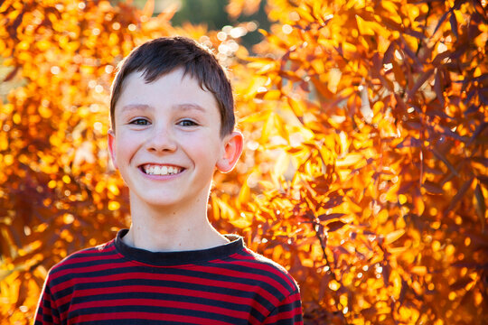 Portrait of a happy ten year old in autumn