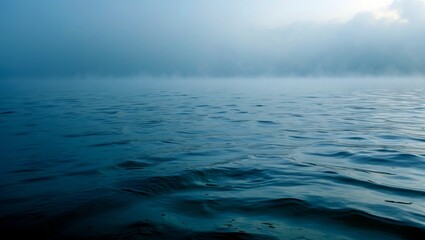 Obraz premium Misty morning calm over serene ocean waters