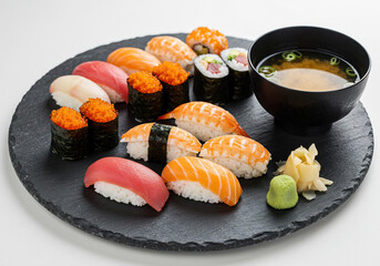 Varied Sushi Platter with Miso Soup and Garnishes on Dark Slate