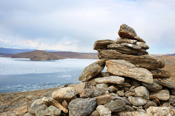  A pyramid of stones built by tourists on a mountain slope.