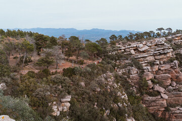 Scenic Landscape with Hikers on Rocky Cliff Trail