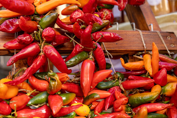 Colorful Hanging Chili Peppers at a Market Stall