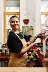 Charming young woman engages with customers at an inviting cafe during a lively morning
