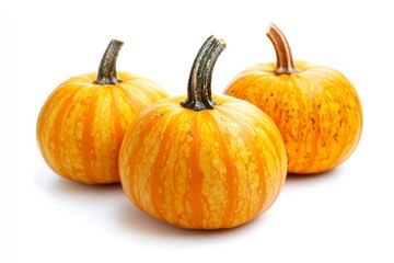 Obraz premium Three Decorative Pumpkins with Orange Stripes on White Background for Fall