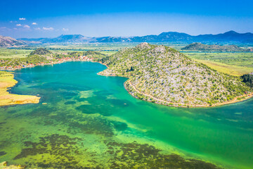 A breathtaking aerial view of Ploce, Croatia, showcasing the stunning Bacina Lakes surrounded by...