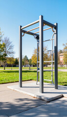 Modern outdoor pull-up bar station in a sunny park setting  