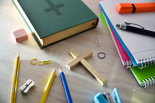 Religious education concept with crucifix and Bible and tools around