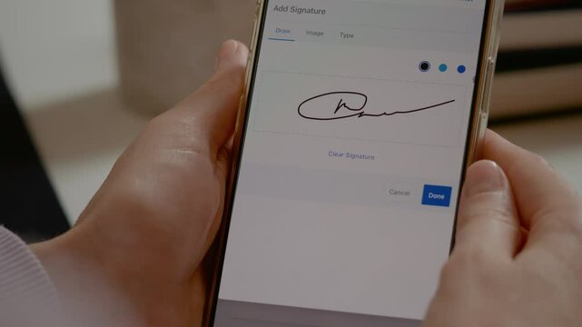 Professional businesswoman digitally signing legal document using smartphone touchscreen, verifying electronic agreement with confident finger tapping
