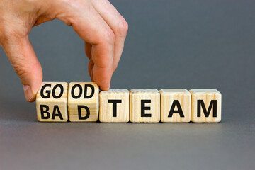 Good or bad team symbol. Concept words Good team Bad team on wooden cubes. Beautiful grey table grey background. Businessman hand. Business and good or bad team concept. Copy space.