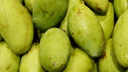 Close-up of fresh green mango ideal for healthy lifestyle and exotic cuisine Ripe mango with...