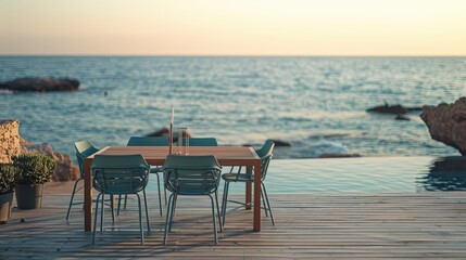 Fototapeta premium Serene seaside dining setup with modern furniture overlooking calm waters at sunset