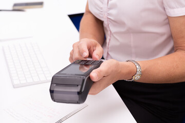 Woman's hands holding EFTPOS terminal to make a payment