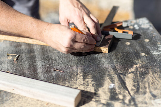 Hands of man measuring DIY project