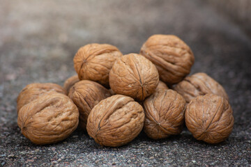 Dry walnuts on cement background