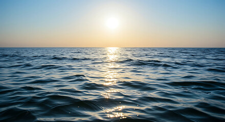 Fototapeta premium Sunlight reflecting on the ocean surface at sunset time