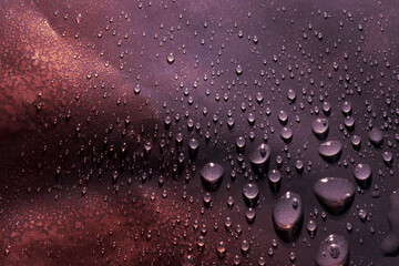 Red powder on gradient background with water drops. Top view