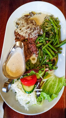 Sliced beef steak with green beans, salad and sauce in konigstein fortress restaurant