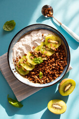 Chocolate granola with fresh fruits, yogurt and chia seeds on the table