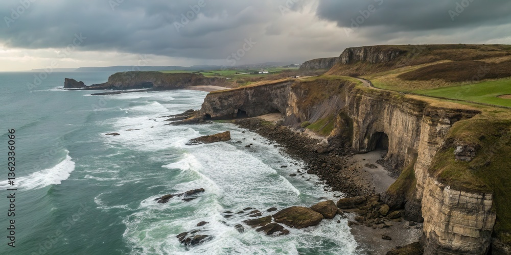 Poster coastal cliffs under dramatic skies with waves crashing below.
