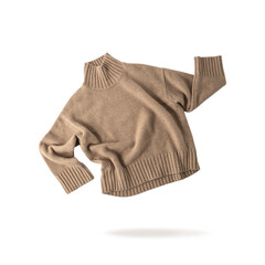 Soft casual  light brown or beige sweater of luxury natural cashmere wool flying isolated on white background. Autumn and winter pure wool clothing.