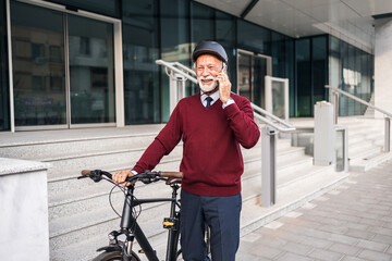 Fototapeta premium Senior Professional Enjoying Commute with Bicycle and Smartphone