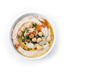 Chickpea hummus with olive oil, parsley and paprika in bowl isolated on white background. Top view. Copy space