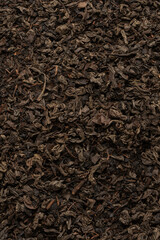 Dried tea leaves as a background.